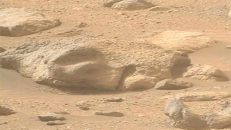 Eerie 'human face' found buried in sand on Mars