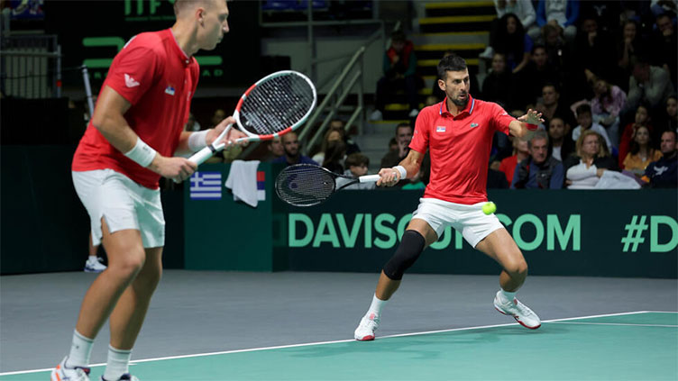 Doubles win for Djokovic secures Serbia's Davis Cup status