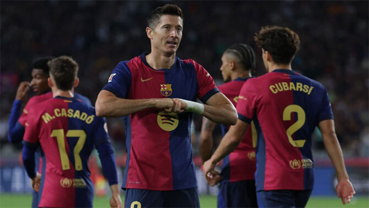 Lewandowski helps Liga leaders Barca past Getafe