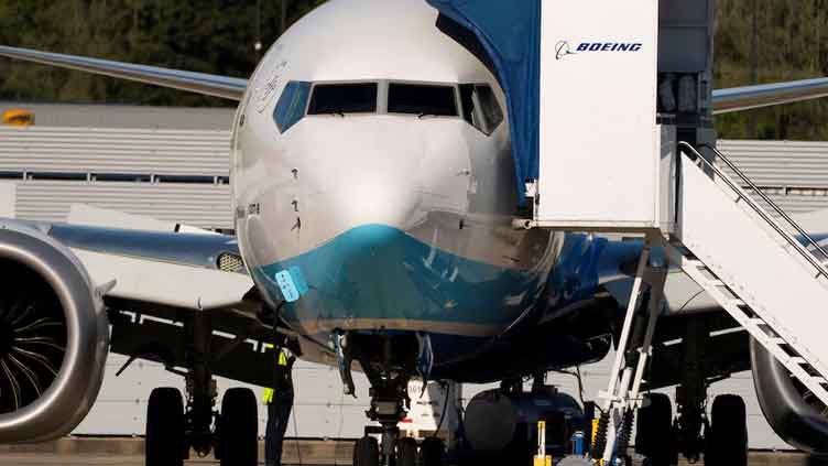 Boeing reports smaller-than-expected loss on higher jet deliveries, shares jump