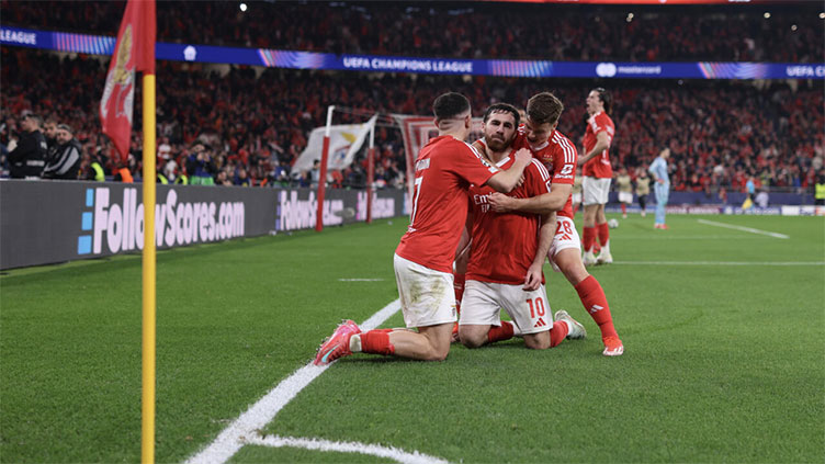 Benfica hold off Monaco to reach Champions League last 16