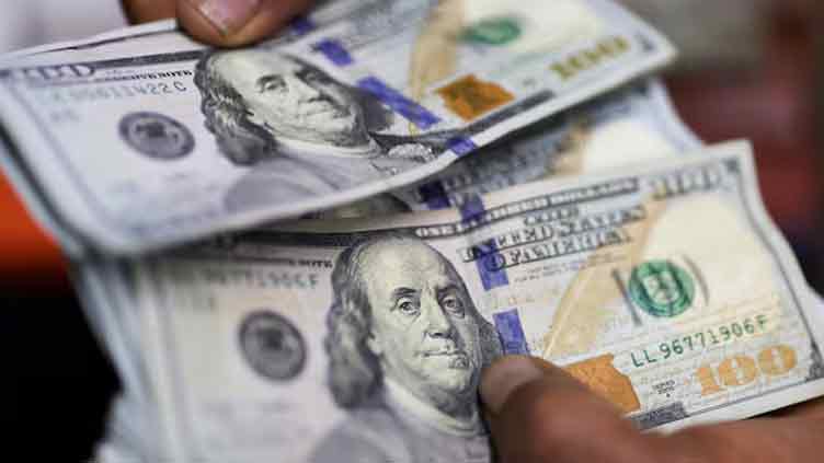 Dollar firms on Ukraine tensions, kiwi slumps as RBNZ slashes rates