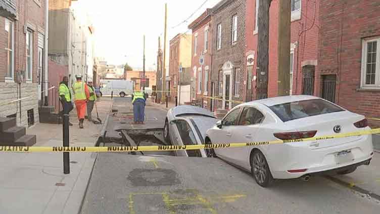 Car plunges into massive sinkhole in Philadelphia