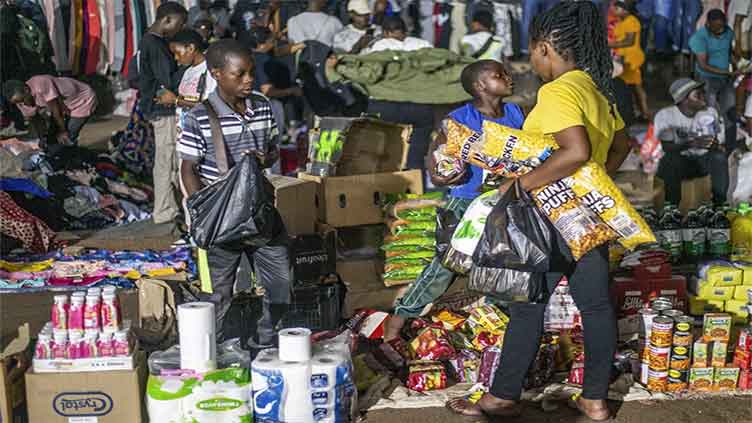 Zimbabwe's new currency woes hit traditional stores while illegal night bazaars flourish