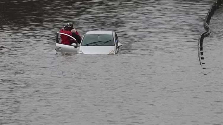 Cars abandoned after overnight rain floods roads in Manchester, England