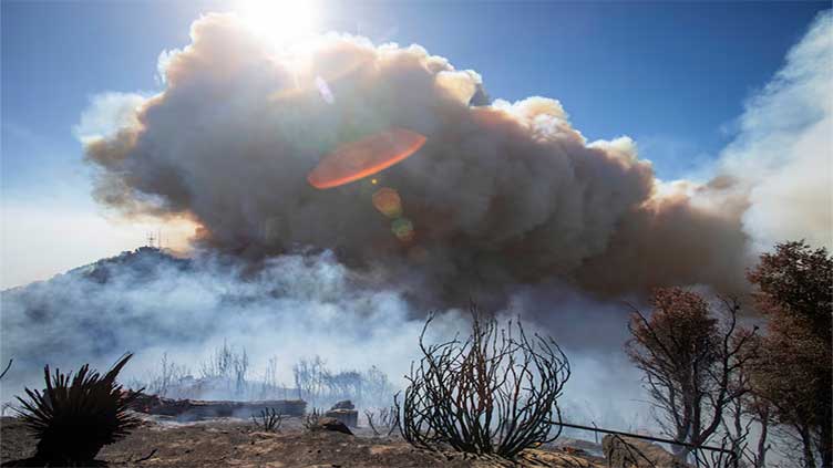 Los Angeles wildfires devour thousands of homes even as fierce winds ease