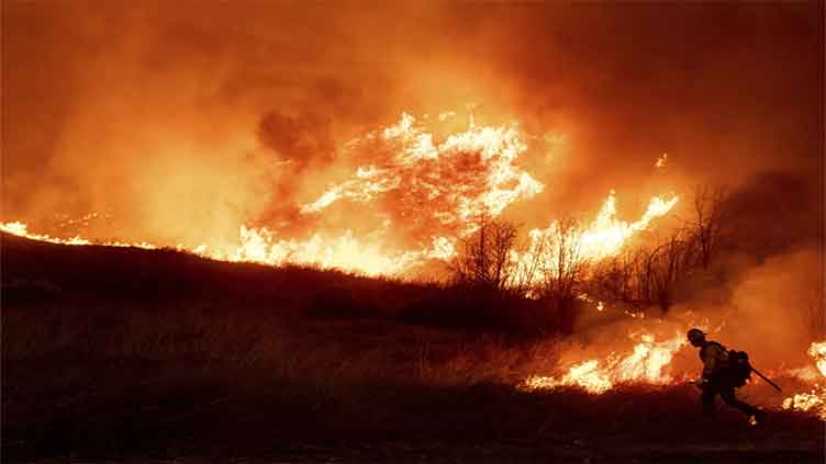 LA area's 2 biggest blazes burn at least 10,000 structures, while new fire leads to more evacuations