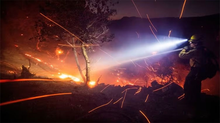 Battle against Los Angeles fires gains ground as intense winds ease