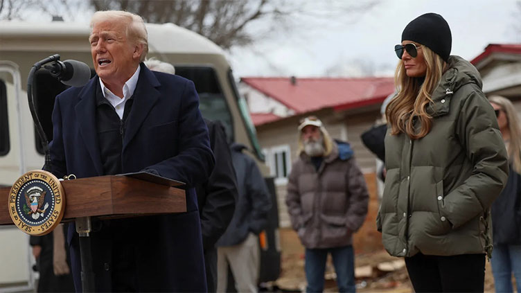 Trump threatens to scrap emergency agency as he visits disaster-hit North Carolina and California