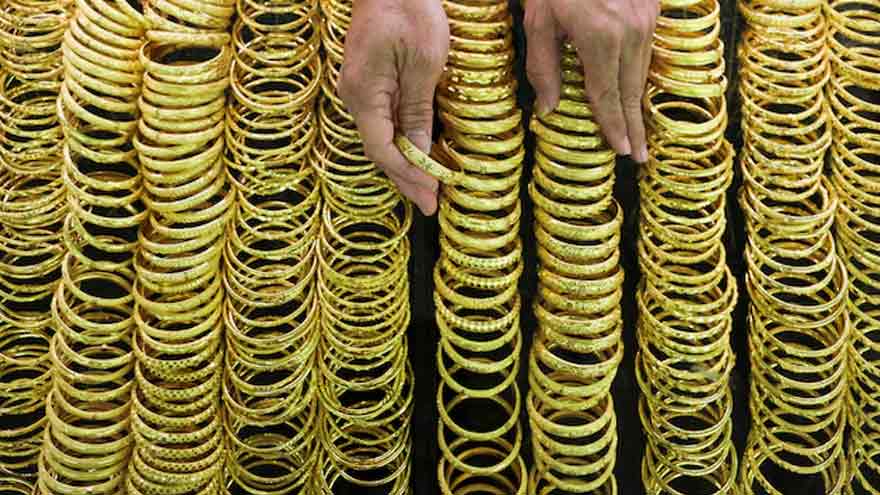 Gold steady as investors await US trade updates, central bank meetings