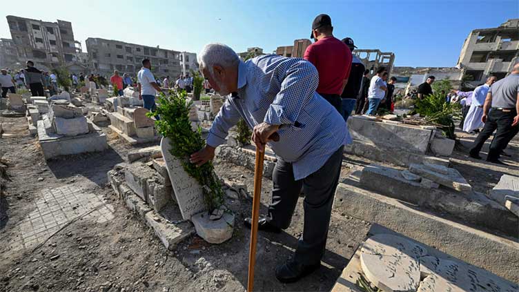 In Syria's devastated Jobar, cemetery comes alive for Eid