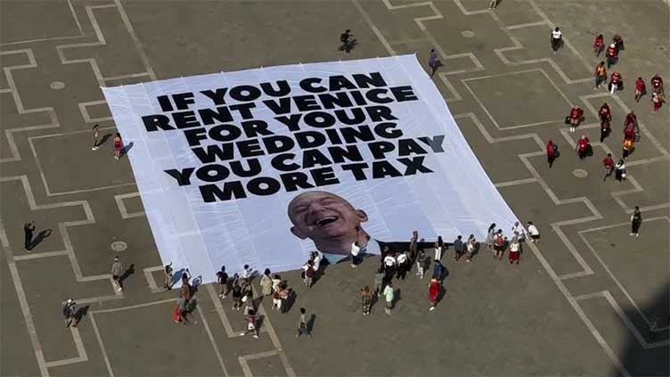'You can pay more tax': activists display anti-Bezos banner in Venice ahead of wedding