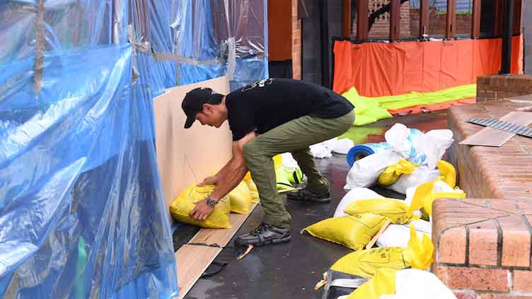 Cyclone Alfred downgraded as millions of Australians stay indoors