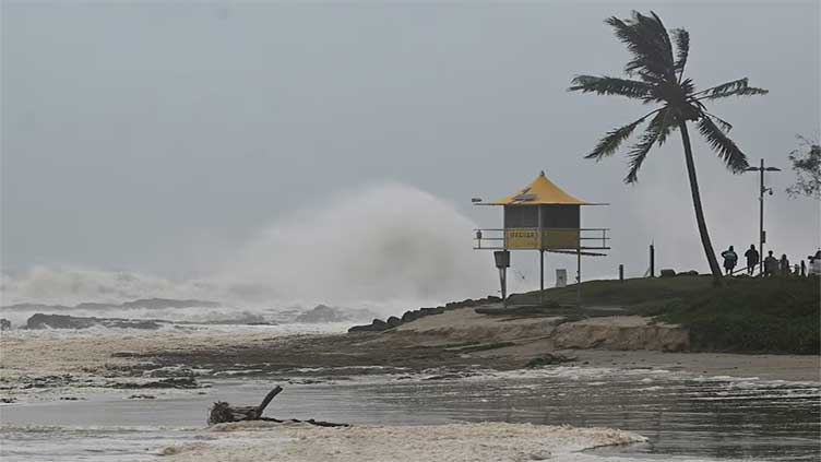 Thousands of Australians without power as ex-tropical cyclone lashes Queensland