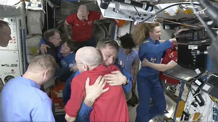 NASA's stuck astronauts welcome their newly arrived replacements to the space station