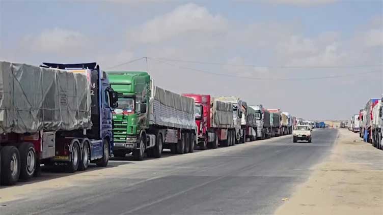 Aid trucks wait in Egypt's Arish as Israel says it will let food into Gaza