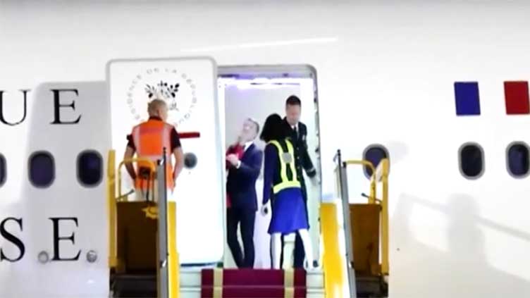 Elysee plays down apparent shove on Macron from wife in Vietnam