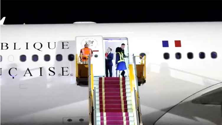 Macron plays down apparent shove from wife in Vietnam
