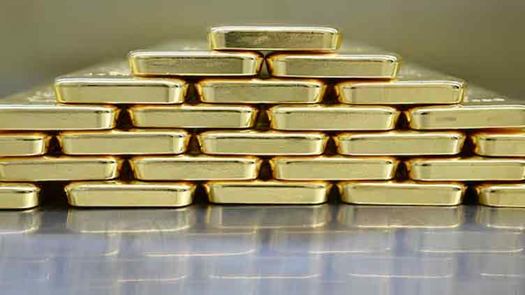 Gold hovers near two-week high on dollar weakness, US fiscal woes