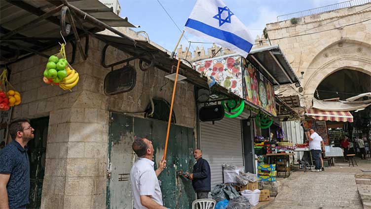 Palestinians clean up after Israeli nationalist march in Jerusalem