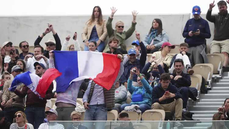 Opponents of French players at the French Open deal with insults and whistling and, yes, even gum