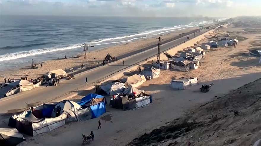 Displaced Palestinians shelter in makeshift roadside tents in central Gaza