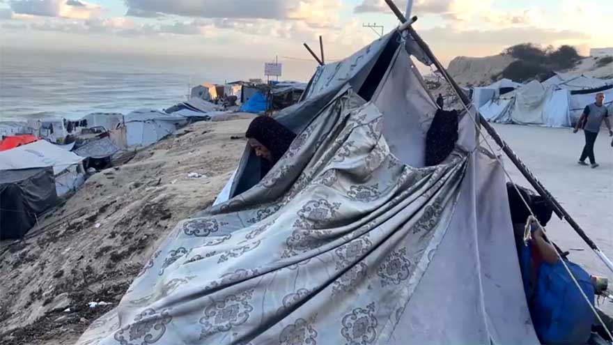 Displaced Palestinians shelter in makeshift roadside tents in central Gaza