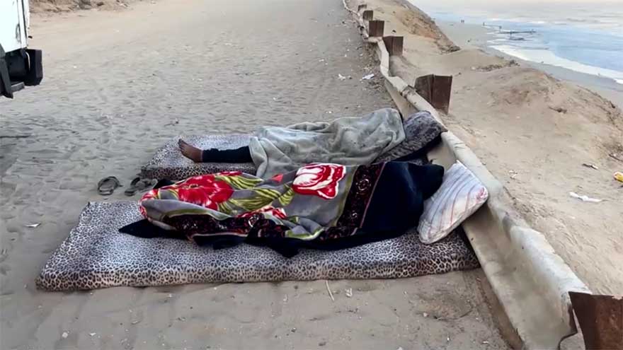 Displaced Palestinians shelter in makeshift roadside tents in central Gaza