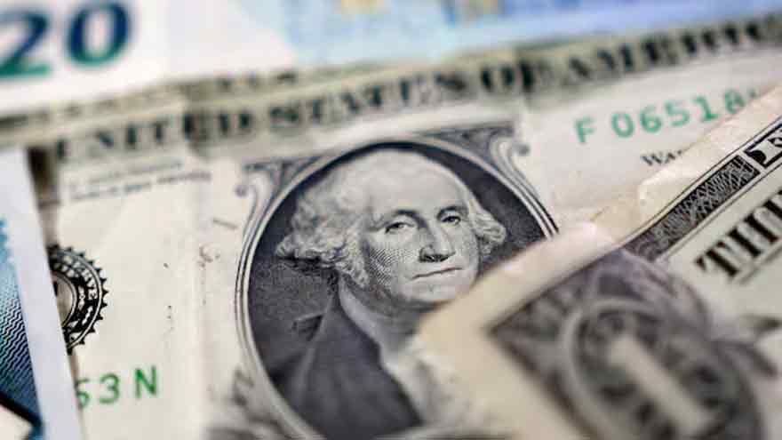 Dollar holds gains as attention turns to spending data for Fed clues