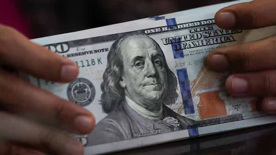Dollar holds gains in thin trading as markets await Fed minutes, US GDP