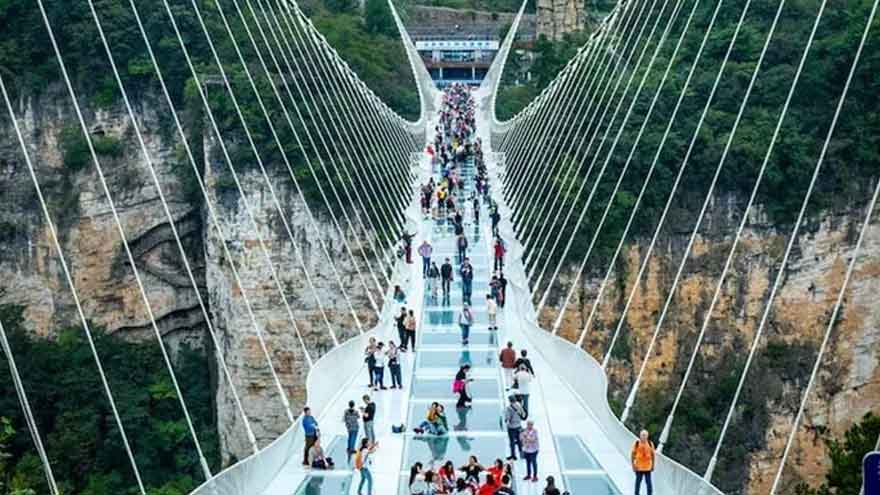 Teenager's umbrella cracks outer panel of China's famous glass skywalk