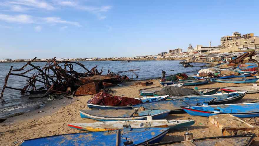 Gazan fishermen patch up dinghies with door frames to keep themselves afloat