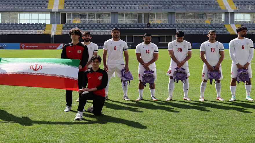Iranian soccer players hold schoolbags in solidarity with slain girls