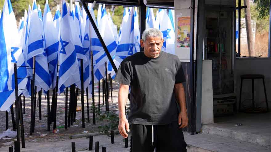 Israeli settlers flank Palestinian cafe with dozens of Israeli flags