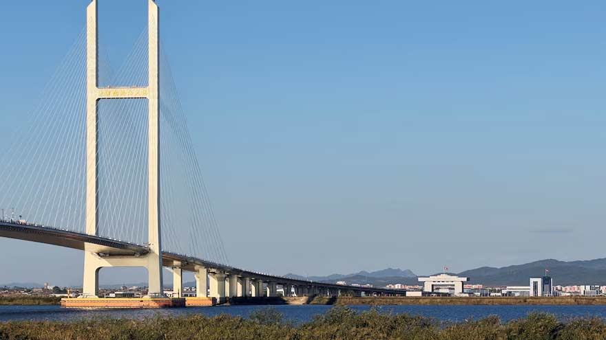 Trucks line up as long-delayed China-North Korea bridge officially opens
